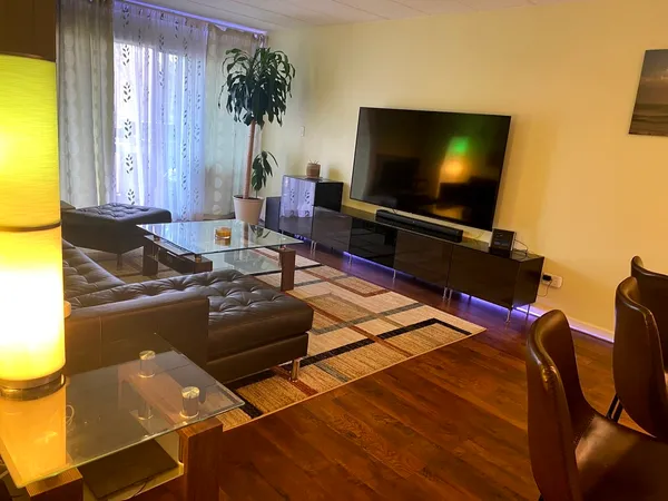 a living room with furniture and a flat screen tv