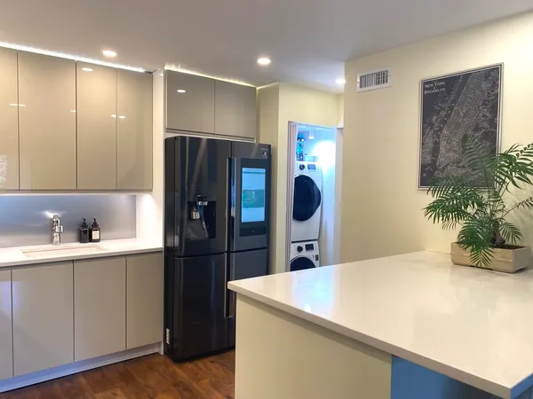 a kitchen with stainless steel appliances a refrigerator and a sink