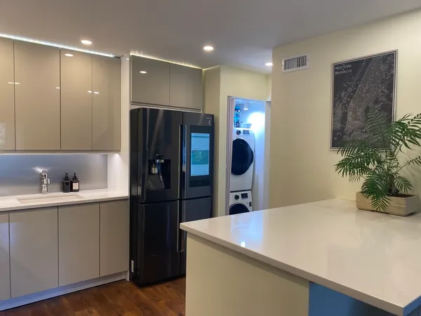 a kitchen with stainless steel appliances a refrigerator and a sink