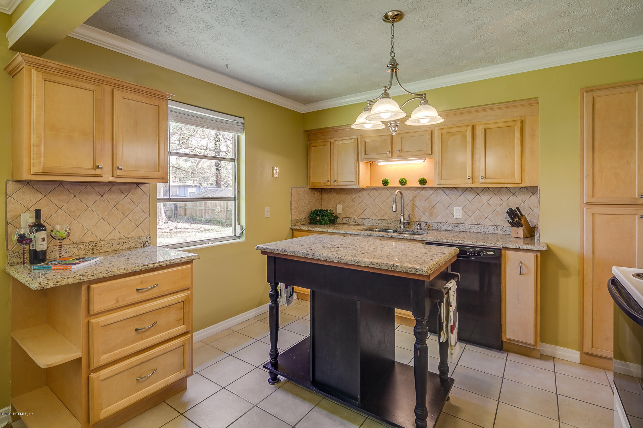 5451 Cardan Road Jacksonville, FL 32244 - Photo 4 of 26 a kitchen with a stove a sink and a refrigerator