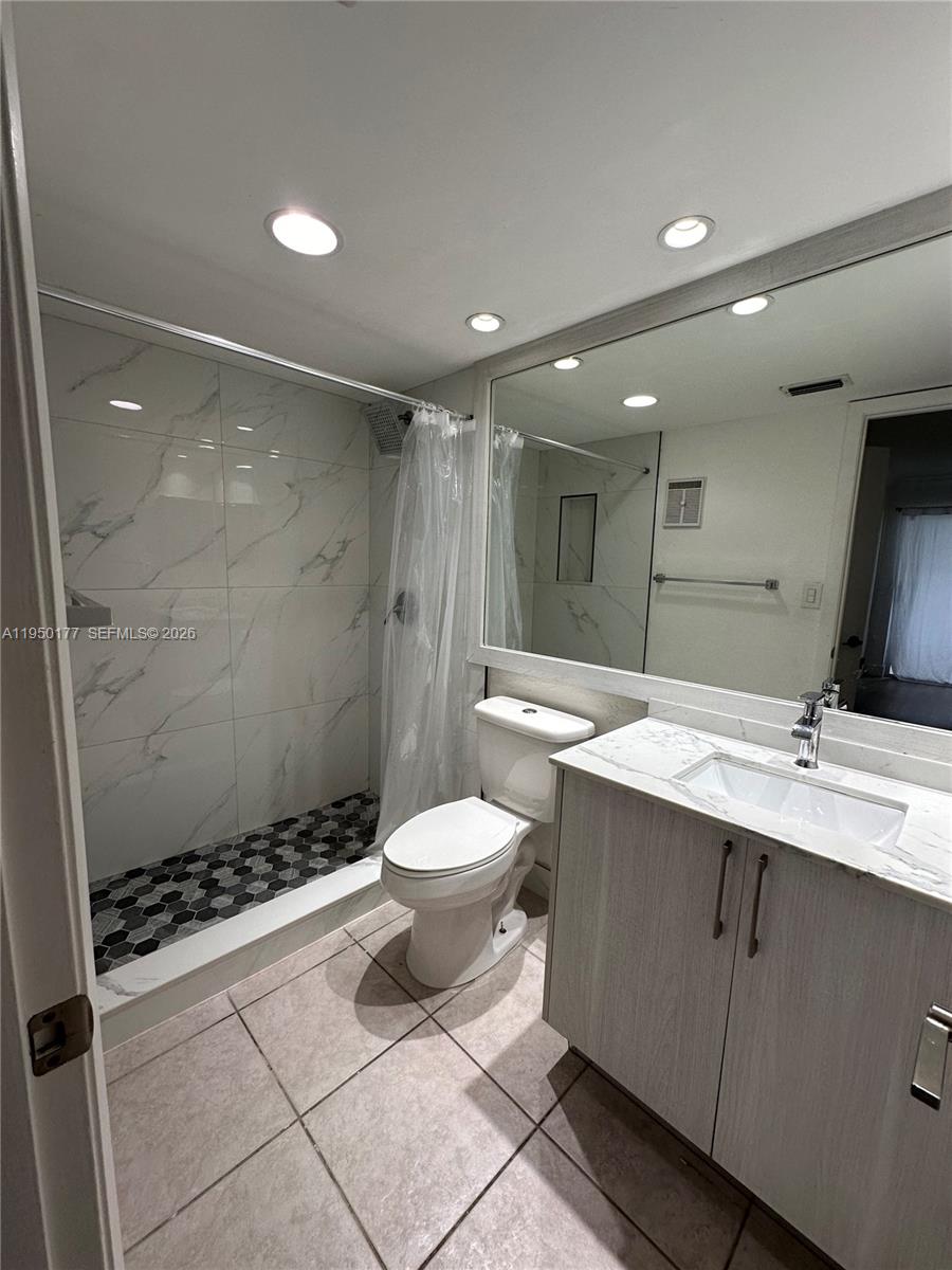 10795 Southwest 108th Avenue, Unit 304 Miami, FL 33176 - Photo 1 of 17 a bathroom with a double vanity sink toilet and shower