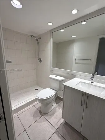 a bathroom with a toilet a sink and shower