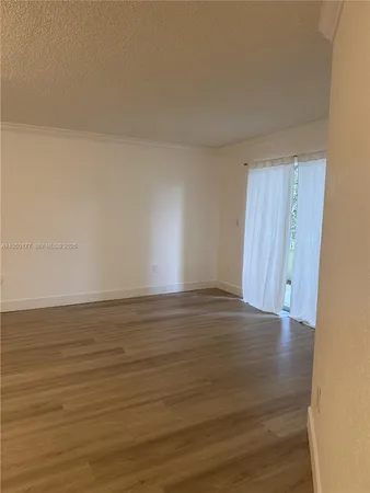 a view of an empty room and wooden floor