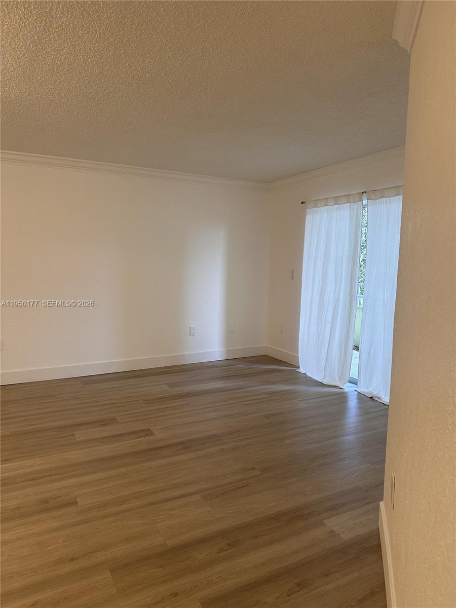 10795 Southwest 108th Avenue, Unit 304 Miami, FL 33176 - Photo 17 of 17 a view of an empty room and wooden floor