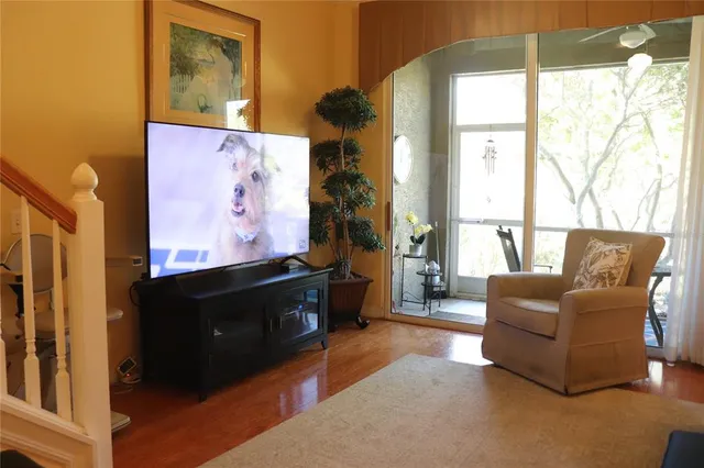 a living room with furniture window and flat screen tv