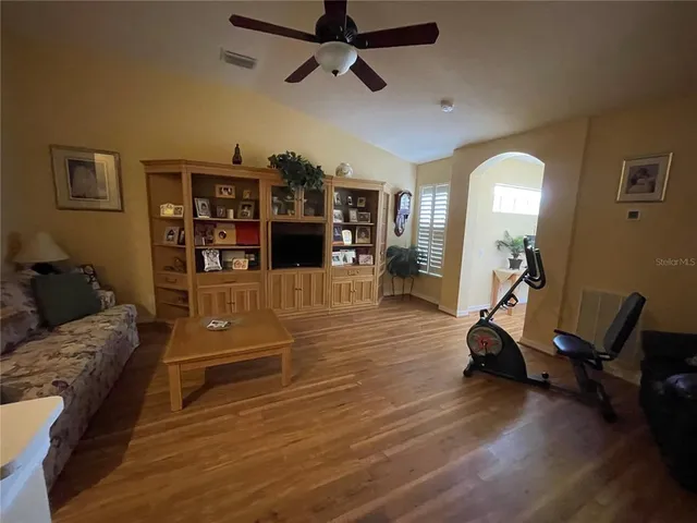 a view of a livingroom with furniture and a bookshelf