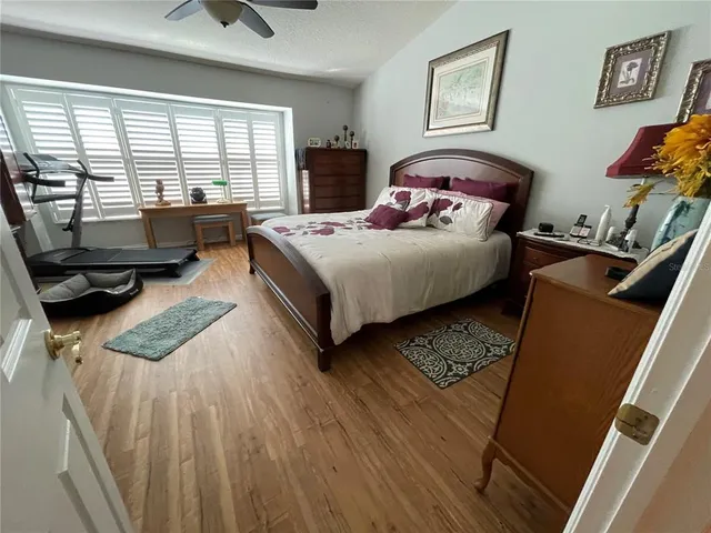 a bedroom with a bed a couch and a window