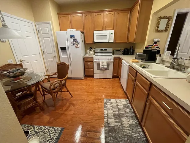 a kitchen with stainless steel appliances granite countertop a sink and a stove