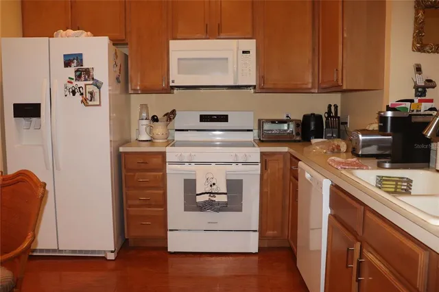 a kitchen with a refrigerator and a stove top oven