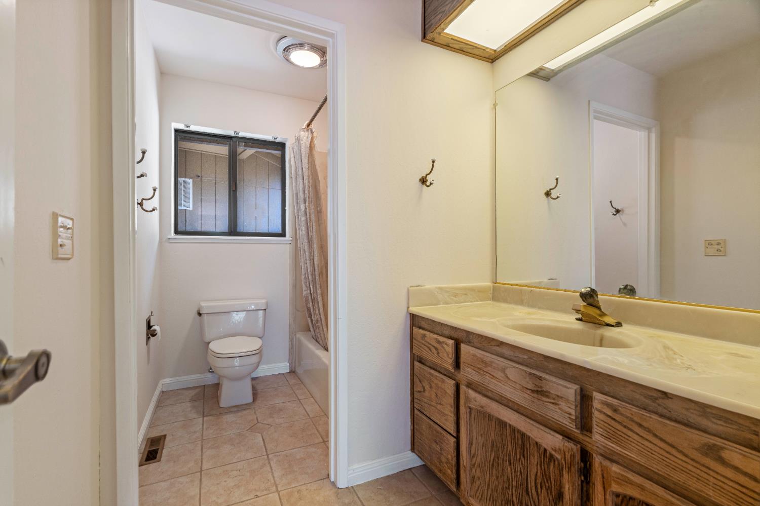 3830 Wilson Loop Placerville, CA 95667 - Photo 13 of 36 a bathroom with a granite countertop sink a toilet and a mirror