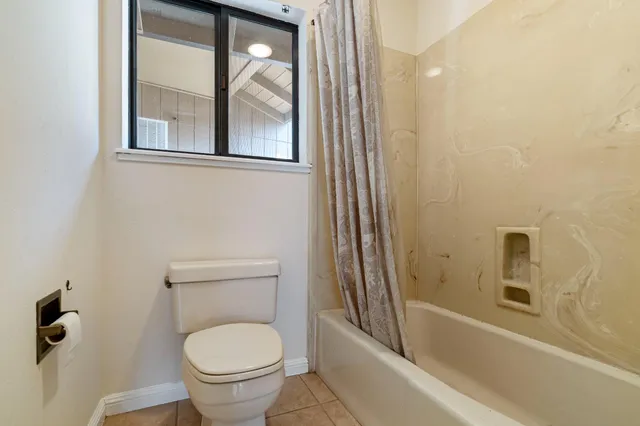 a bathroom with a toilet and a bathtub