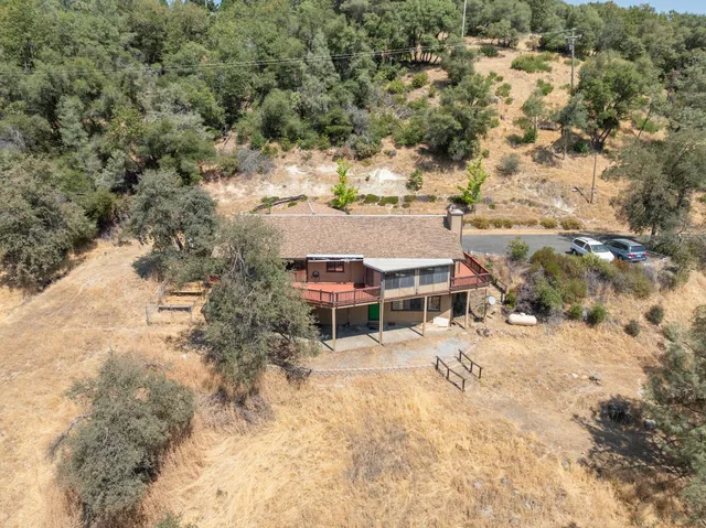 an aerial view of residential houses with yard