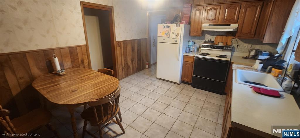 230 New Street Lyndhurst, NJ 07071 - Photo 6 of 10 a kitchen with stainless steel appliances a stove a refrigerator and wooden cabinets