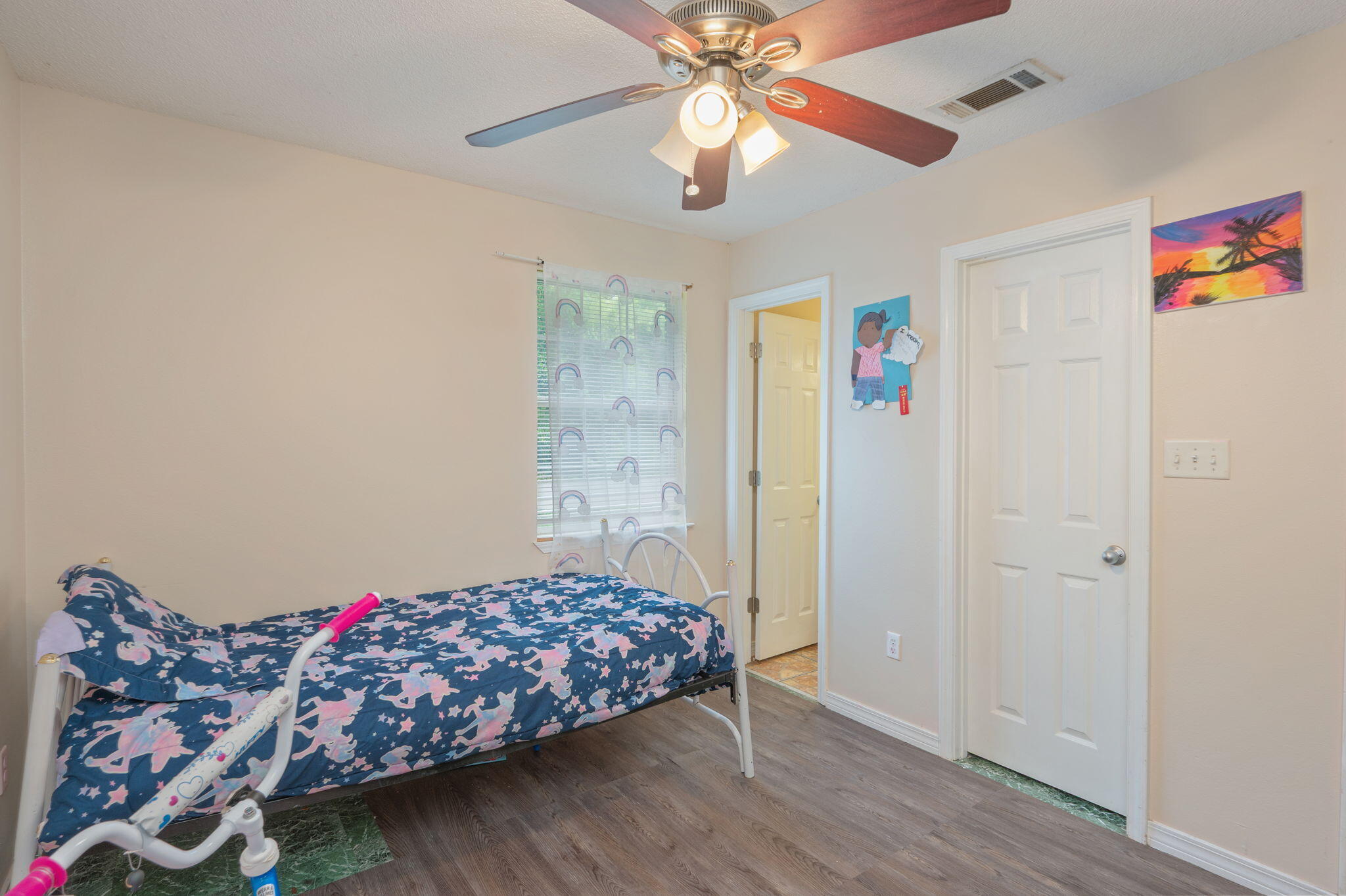 834 McDonald Street Crestview, FL 32536 - Photo 15 of 35 a bedroom with bed and a chandelier fan