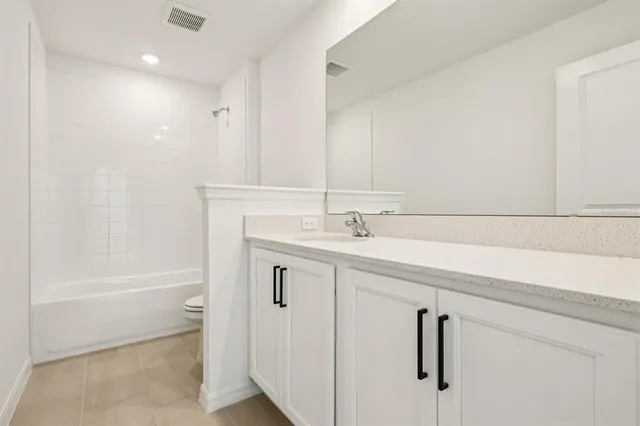 a bathroom with a bathtub sink a mirror and a shower