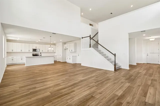 a view of a kitchen with wooden floor and a sink