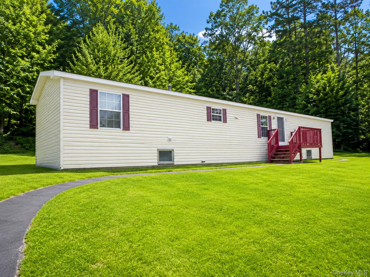 182-184 Mutton Hill Road Neversink, NY 12765 - Photo 18 of 36 Cream-colored vinyl siding exterior featuring maroon shutters and a coordinating maroon-painted deck with stairs