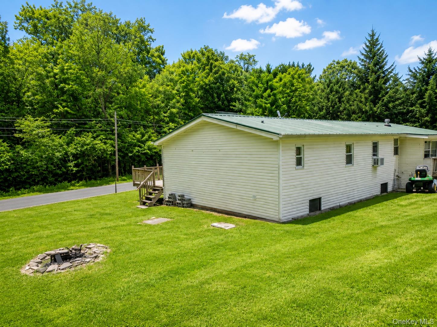 182-184 Mutton Hill Road Neversink, NY 12765 - Photo 2 of 36 Expansive green lawn featuring a stone fire pit