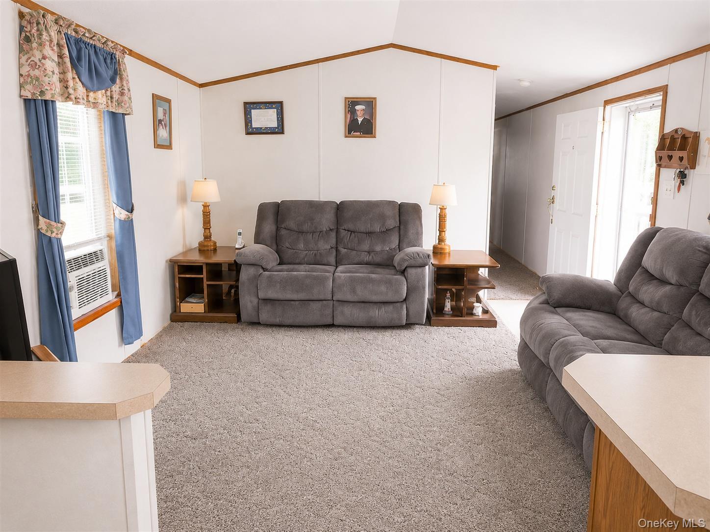 182-184 Mutton Hill Road Neversink, NY 12765 - Photo 23 of 36 Living area featuring light gray carpet, white walls with wood-finish trim, and a window with blinds