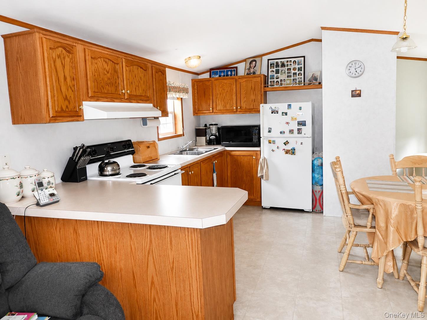 182-184 Mutton Hill Road Neversink, NY 12765 - Photo 24 of 36 Kitchen featuring wood cabinetry, a white electric range, and a white refrigerator