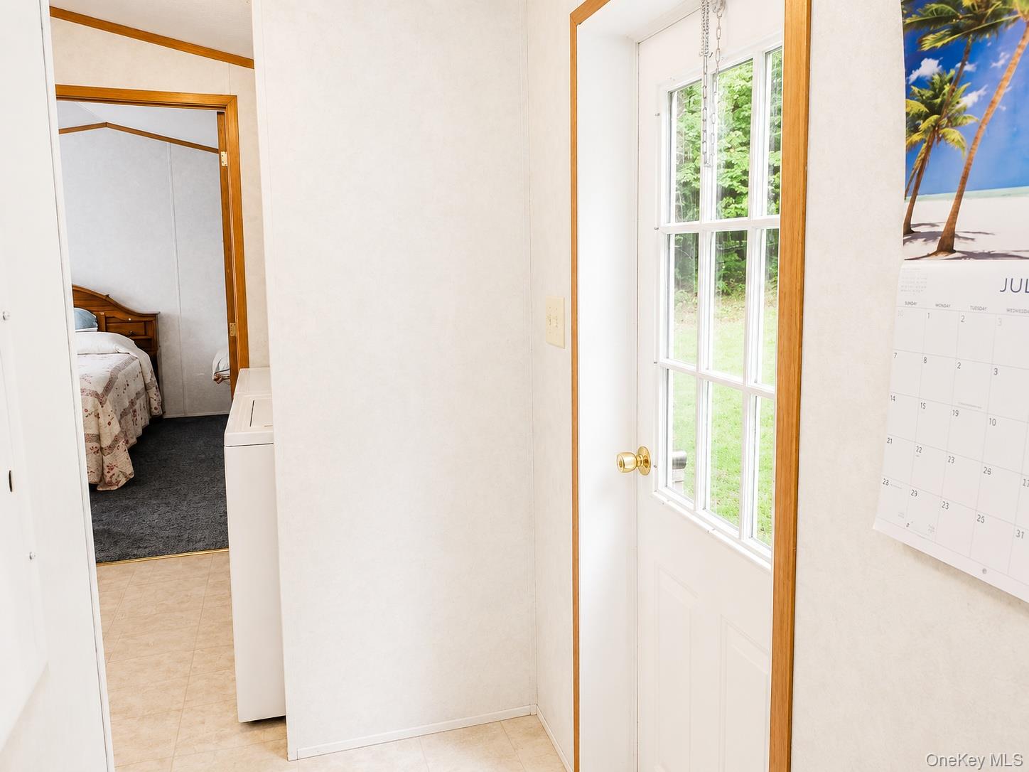 182-184 Mutton Hill Road Neversink, NY 12765 - Photo 25 of 36 White paneled door with glass inserts and a brass doorknob