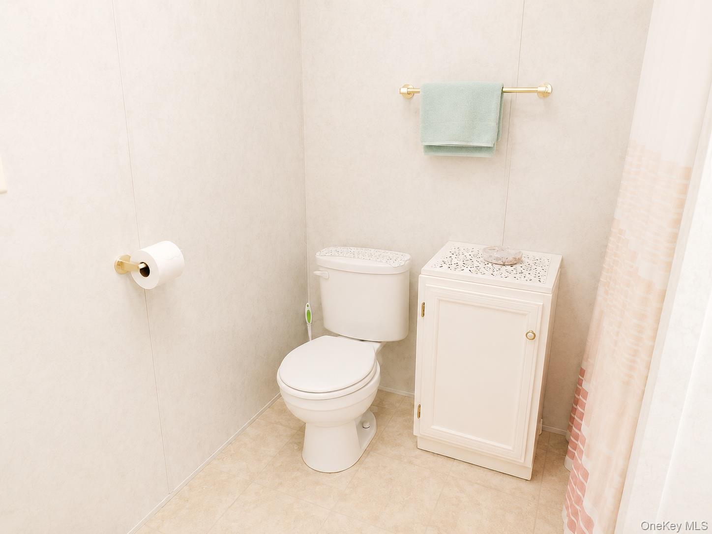 182-184 Mutton Hill Road Neversink, NY 12765 - Photo 29 of 36 Bathroom featuring light-toned paneling, a white toilet, and a compact storage cabinet with a decorative top