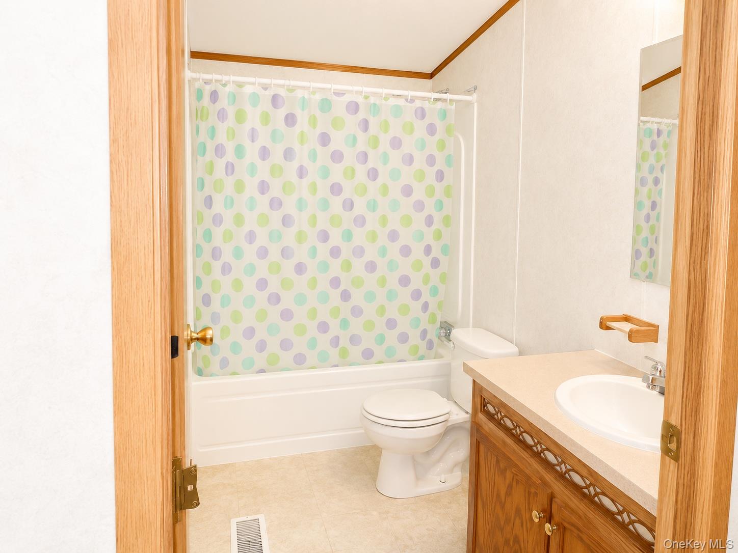 182-184 Mutton Hill Road Neversink, NY 12765 - Photo 32 of 36 Bathroom featuring a white tub, toilet, and a wood-finish vanity with a light-colored countertop
