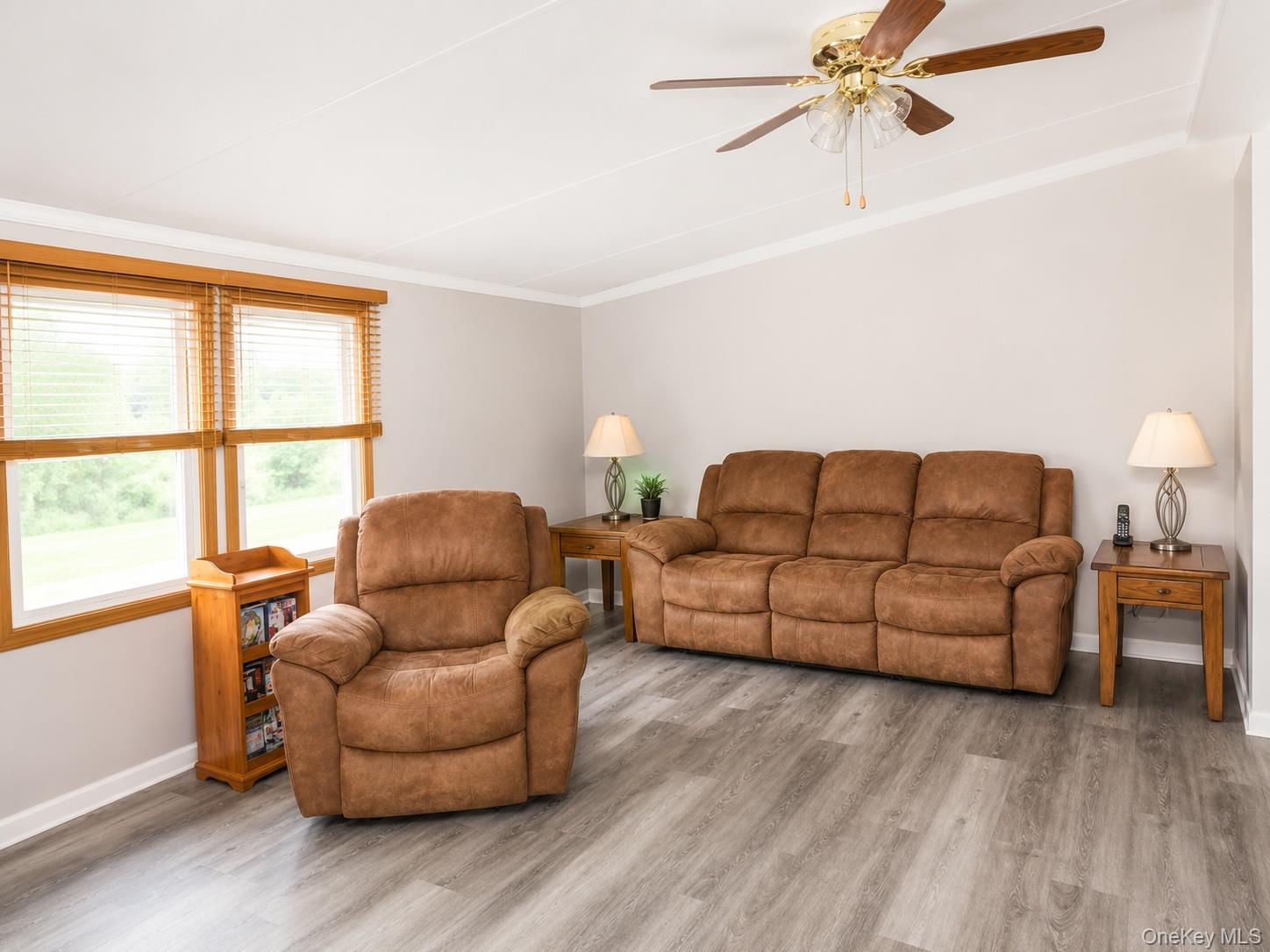 182-184 Mutton Hill Road Neversink, NY 12765 - Photo 4 of 36 Spacious room featuring wood-finish flooring, light-toned walls, and a ceiling fan with light kit