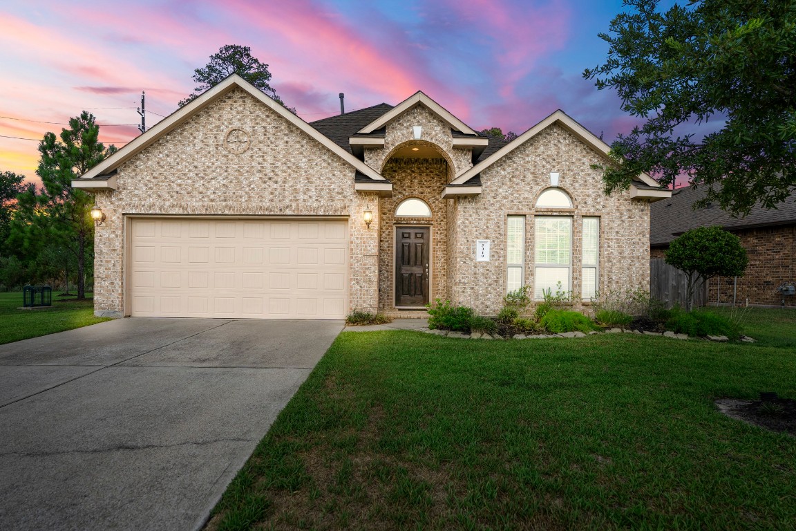 a front view of a house with a yard and garage