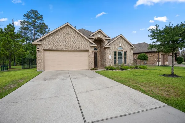 a front view of house with yard and green space