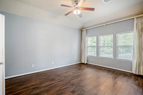 a bathroom with a tub a sink double vanity and a mirror