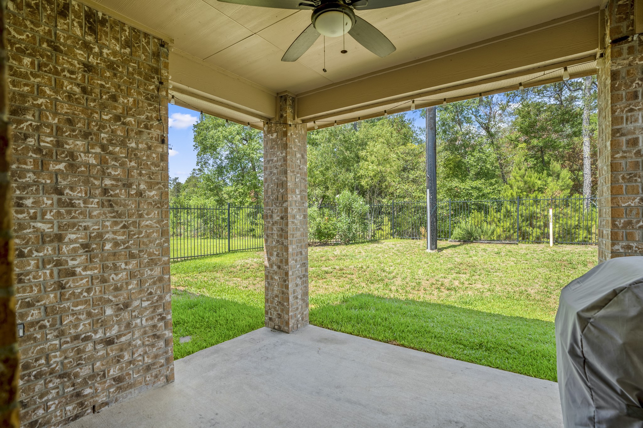 5319 Claymore Meadow Lane Spring, TX 77389 - Photo 27 of 33 A beautiful and relaxing outdoors offers a large covered patio, with ceiling fans, and wonderful views of the greenspace out back.