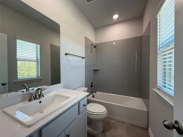 a bathroom with a sink toilet