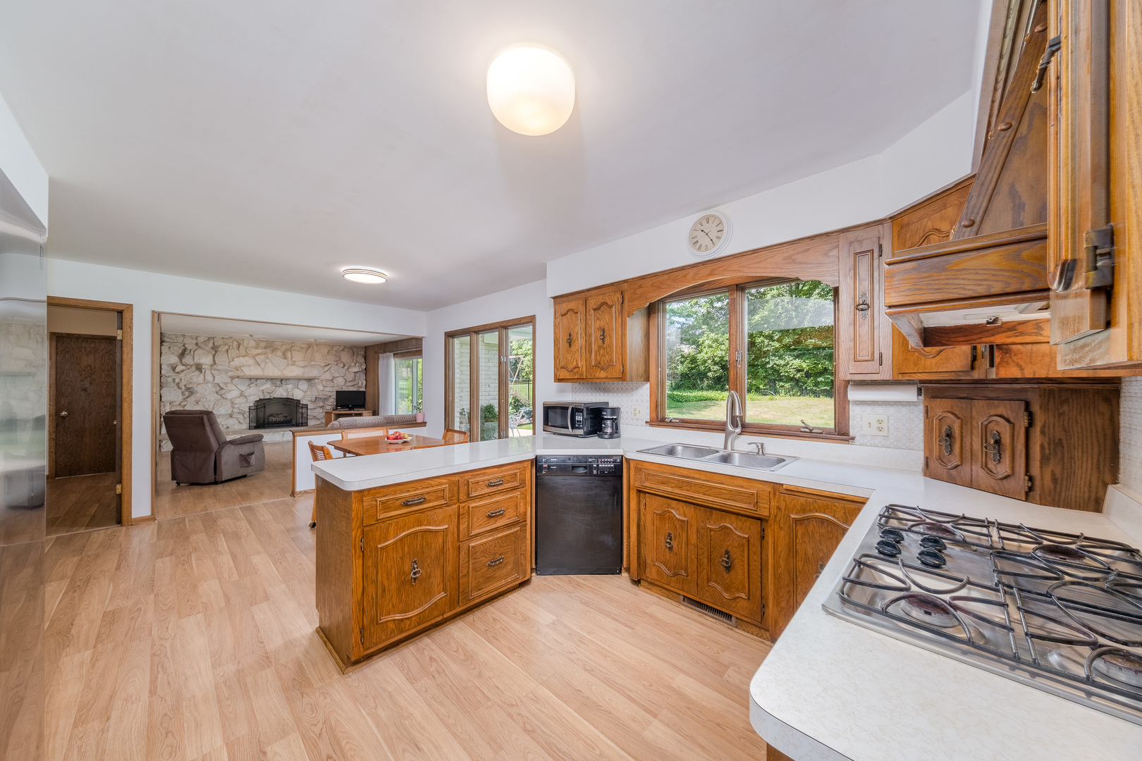 8436 Clynderven Road Burr Ridge, IL 60527 - Photo 13 of 39 a kitchen with stove a sink and a refrigerator