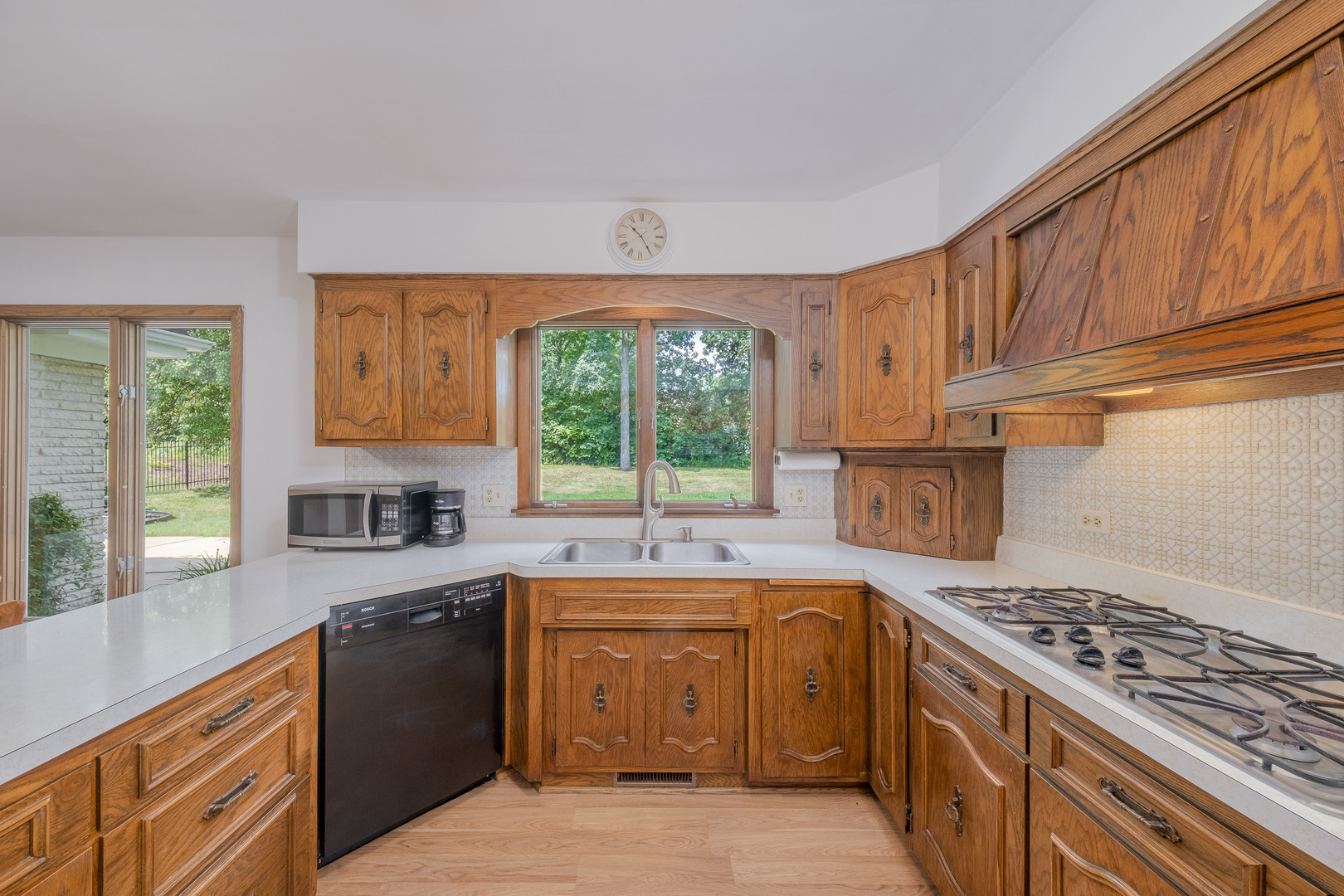 8436 Clynderven Road Burr Ridge, IL 60527 - Photo 14 of 39 a kitchen with a sink stove and cabinets