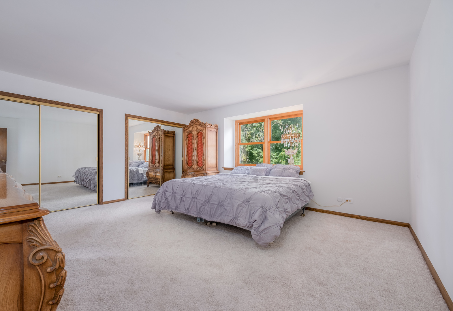 8436 Clynderven Road Burr Ridge, IL 60527 - Photo 18 of 39 a spacious bedroom with a bed and large windows