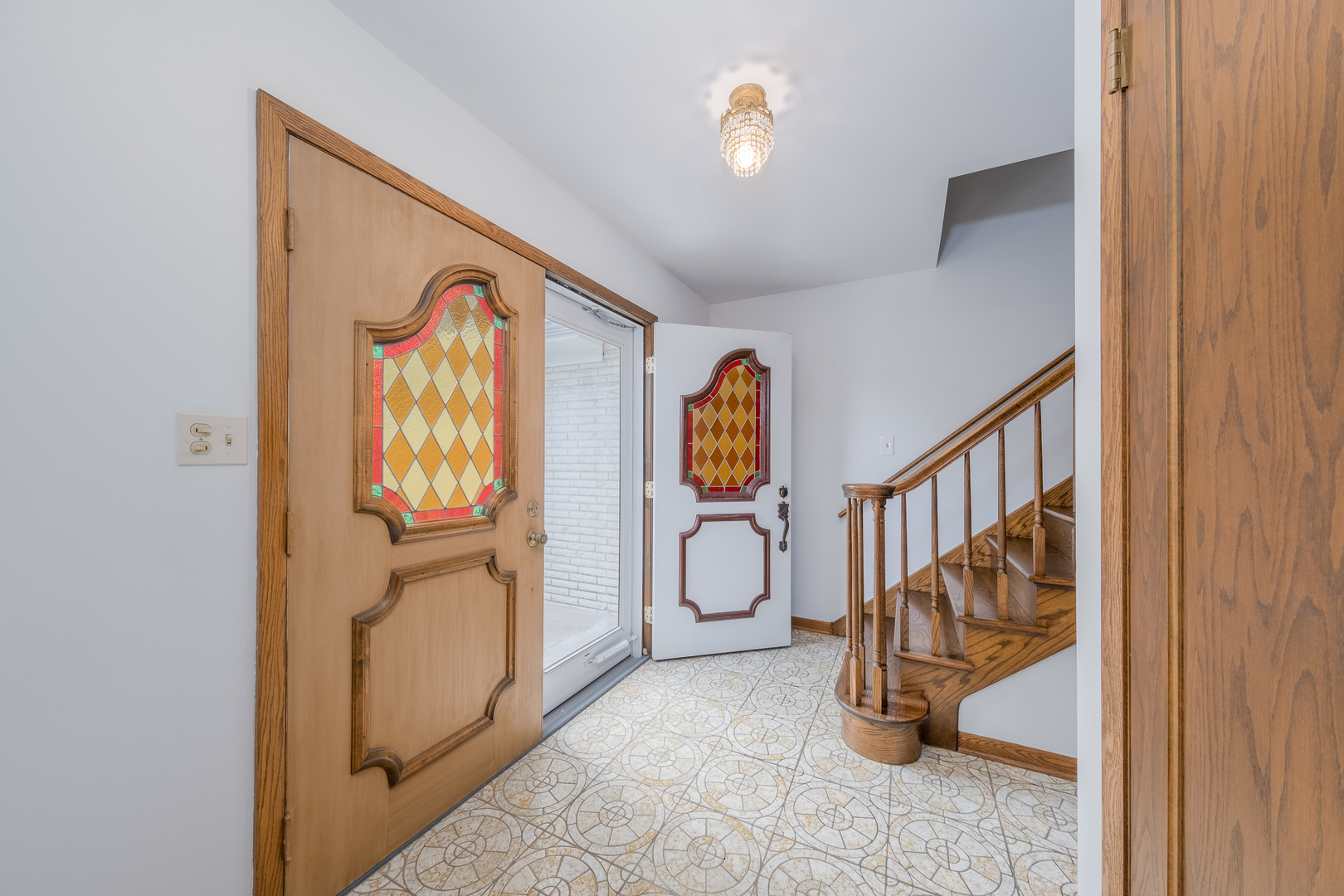 8436 Clynderven Road Burr Ridge, IL 60527 - Photo 6 of 39 a view of a hallway with entryway windows and couch