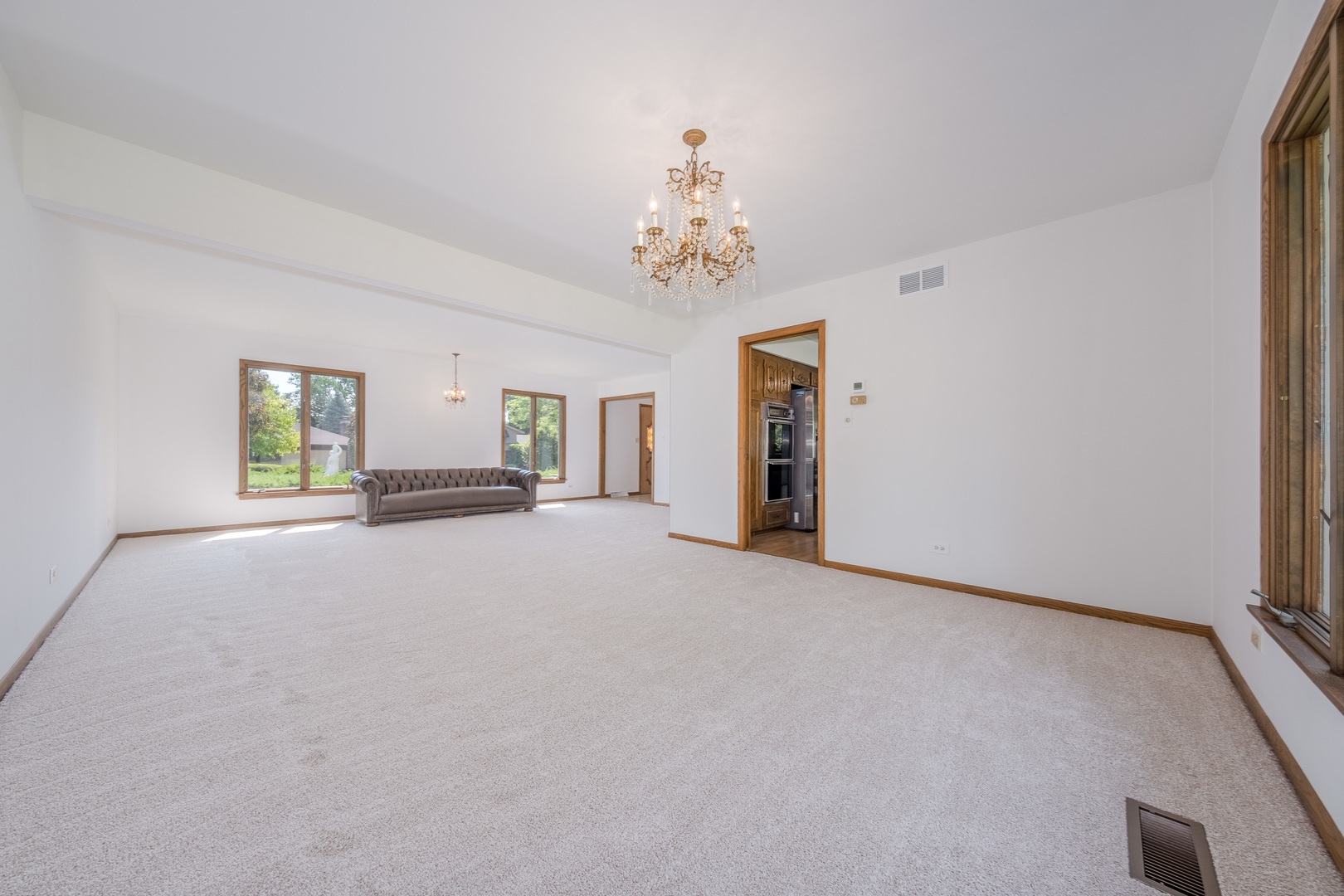 8436 Clynderven Road Burr Ridge, IL 60527 - Photo 8 of 39 a view of a livingroom with a chandelier fan and windows