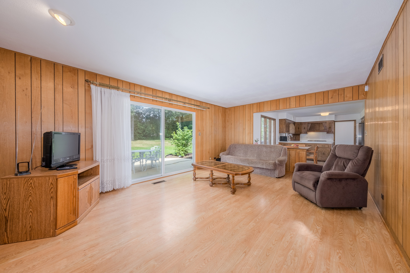 8436 Clynderven Road Burr Ridge, IL 60527 - Photo 10 of 39 a living room with furniture and a flat screen tv