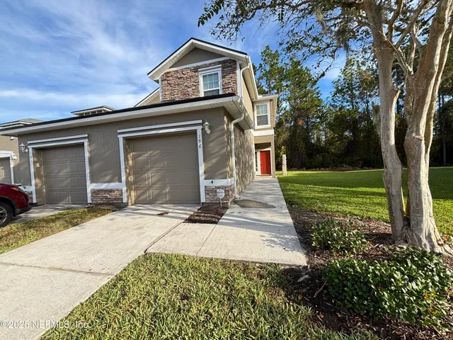 a front view of a house with a yard