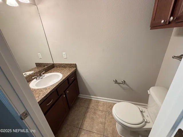 a bathroom with a sink a toilet a mirror and vanity
