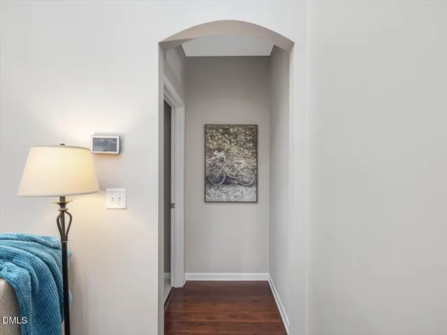 a bedroom with a large bed chandelier and a window
