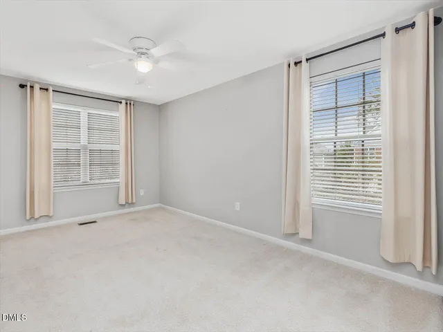 a bathroom with a double vanity sink toilet and a mirror