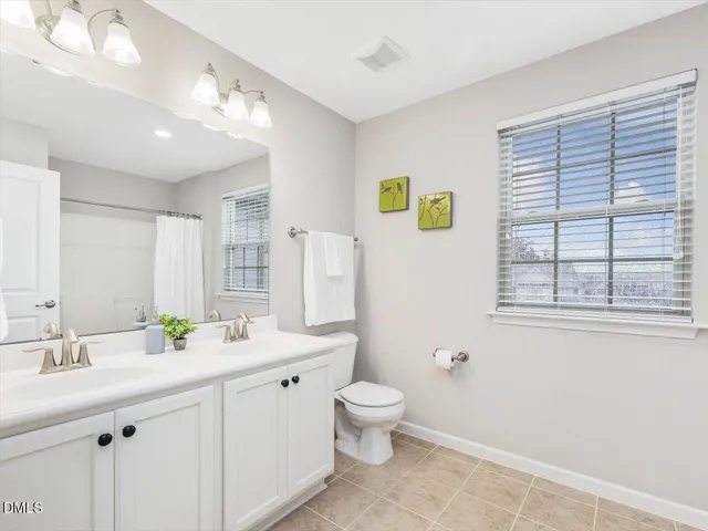 a bathroom with a shower curtain and a bathtub