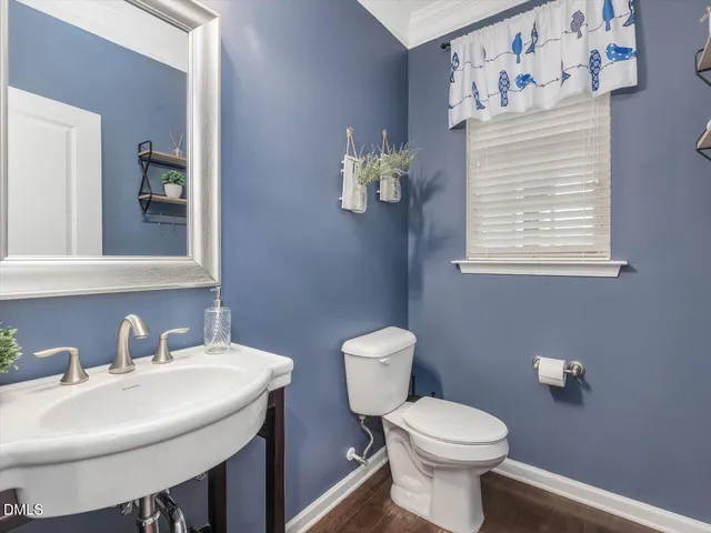 a bathroom with a toilet a sink and a mirror