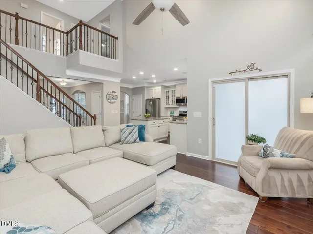 a living room with furniture and a ceiling fan