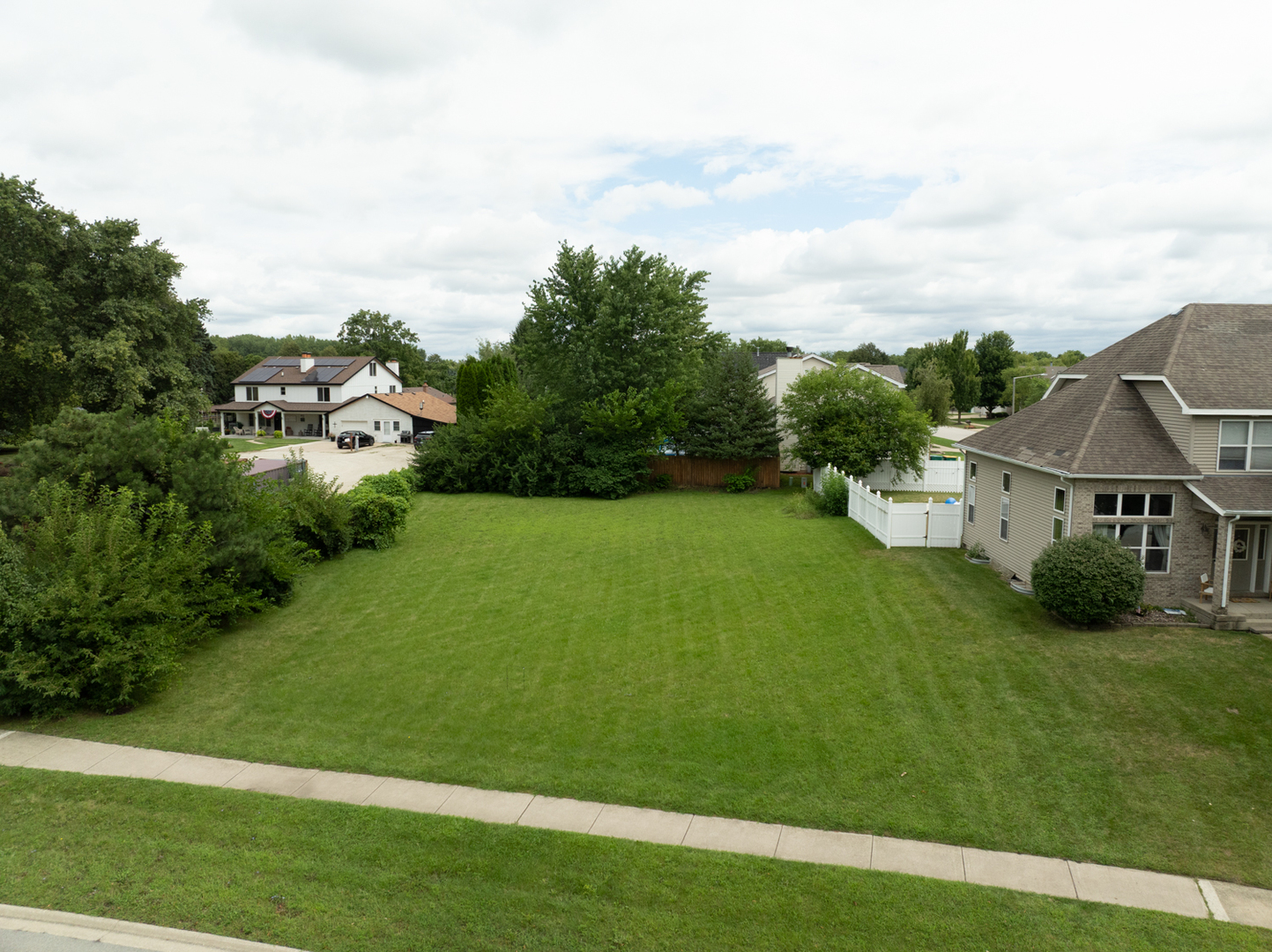 22604 Prairie Crossing Plainfield, IL 60544 - Photo 2 of 7 a view of a house with a big yard potted plants and large tree