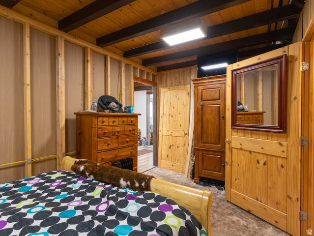 5082 Pine Crest Road Evanston, UT 82930 - Photo 19 of 25 Wood-paneled ceiling with dark exposed beams