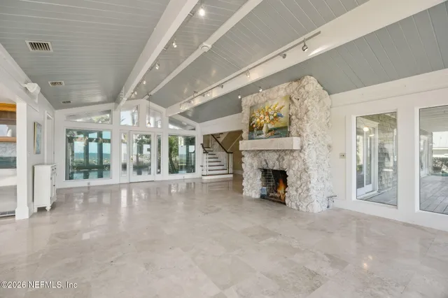 a view of a house with a small yard plants and large tree