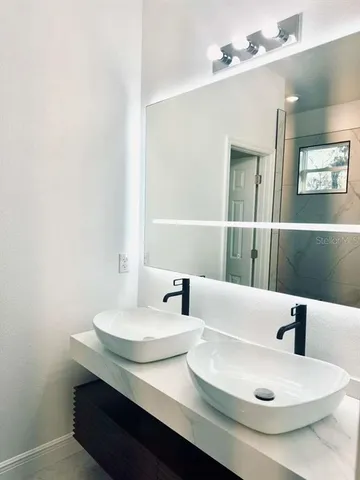 a bathroom with a sink and a mirror